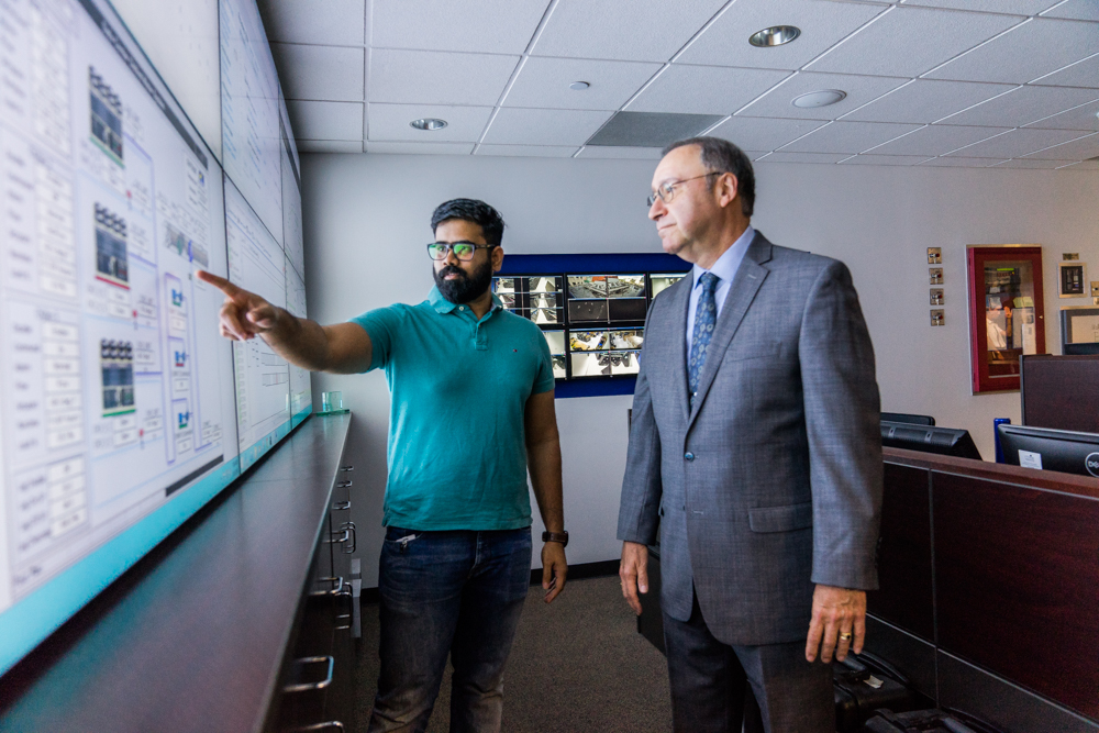 UT Health Science student and professor analyzing board of information