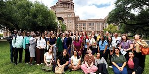 Group poses in front of Texas Capitol
